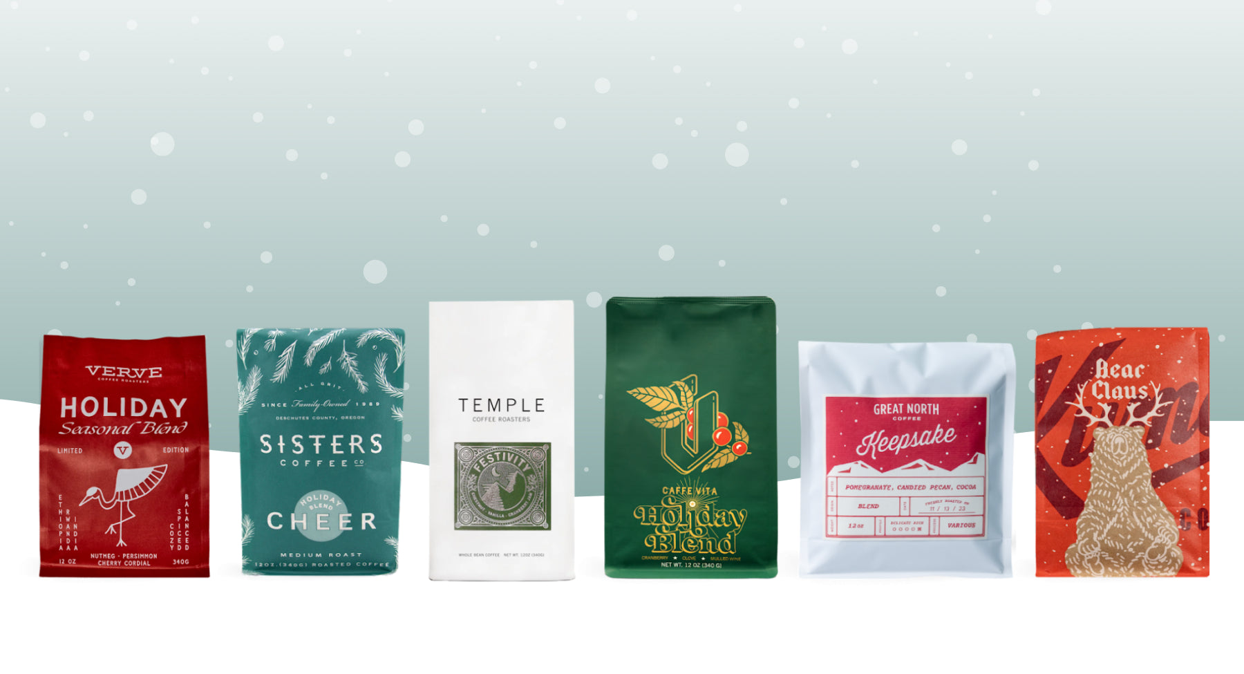 Row of festive coffee bags displayed against a pale snowy backdrop